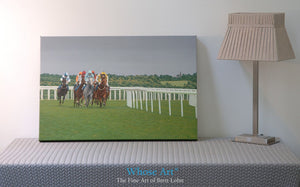 Racehorse wall art canvas print of horses racing at Epsom during an evening meeting. A grey horse leads the field around a bend