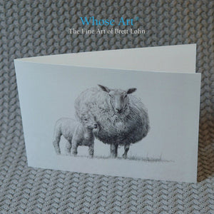 Black & white greeting card of a detailed pencil drawing of a sheep with a lamb leaning against it. Card is blank inside