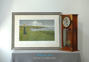 A framed art print of a mystical art scene showing a woman on a grassy cliff with a castle behind her, beneath a stormy sky.