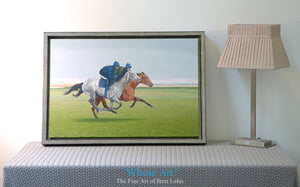 Canvas art print of a Galloping Grey Horse painting showing racehorses working on the gallops. Canvas print rests on a table.