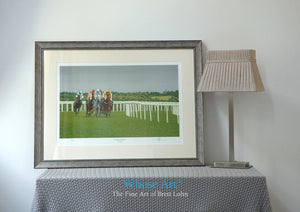 A Framed Horse racing art print of a painting of horses racing at Epsom at an evening meeting. In an interior design setting.