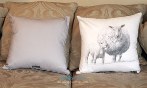 Sheep and lamb art cushion placed on a sofa