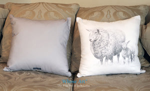 Sheep and lamb drawn together on a cushion, placed on a sofa