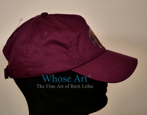 Burgundy cap with horse racing design. Cap is seen from the right hand side.