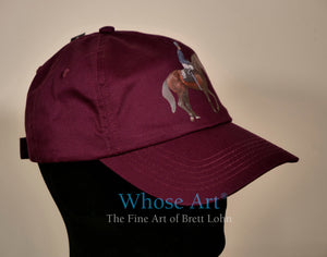 Horse riding wear hat with a painting of a horse and jockey on the front.