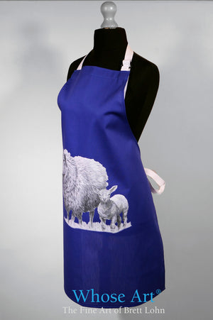 Sheep gift idea of a navy apron with sheep and lamb picture, hanging on a female mannequin.