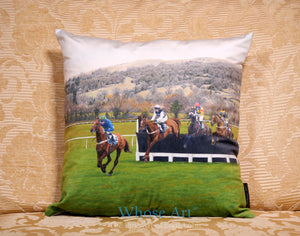 Sofa cushion with theme of horse racing showing horses jumping
