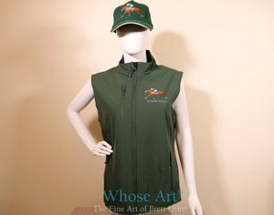 horse racing clothing for women showing a green bodywarmer gilet with a racehorse and jockey design, printed on the chest. Model is wearing a matching green horse racing hat.