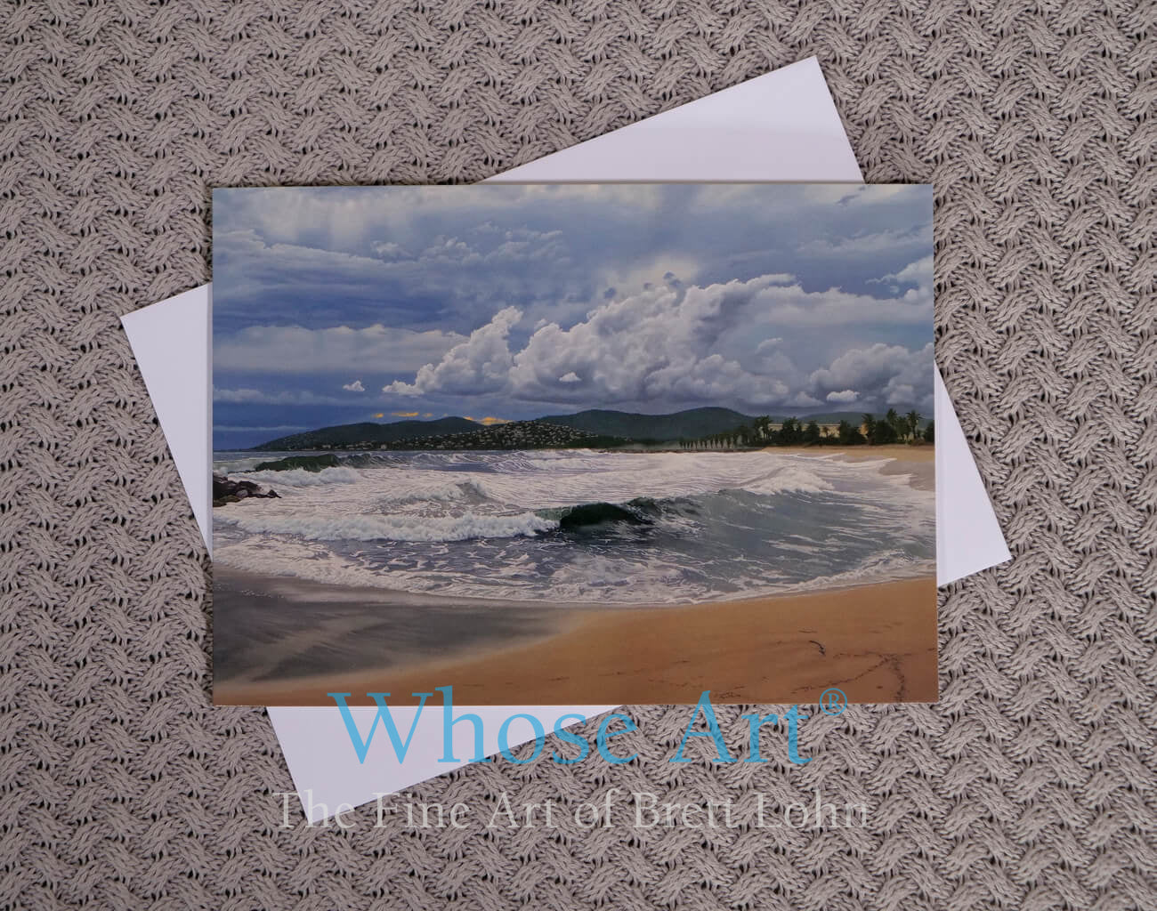 ocean waves beneath a stormy sky in an oil painting on a greeting card.