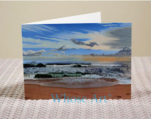 Sandy beach seascape greeting card on a table