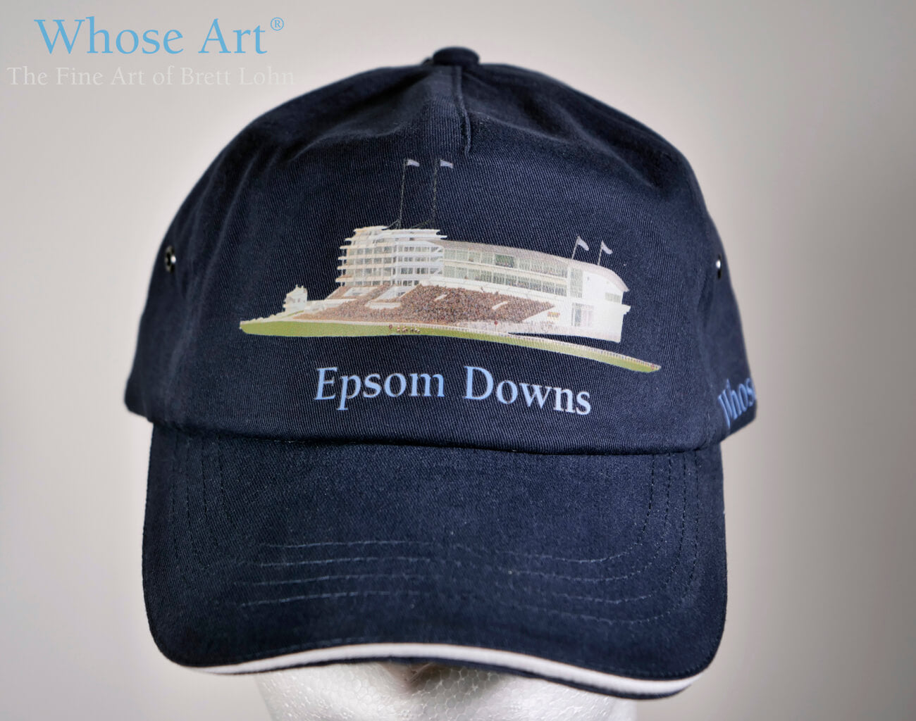 horse racing hat with a picture of Epsom Downs Racecourse on the front
