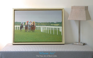 Epsom races are painted on this Canvas art print framed in gold. Horses gallop around a bend beneath a stormy summer sky.