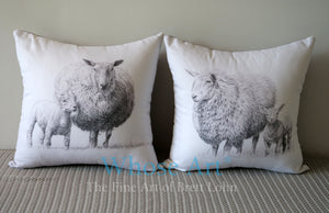 A pair of sheep art cushions with a drawing of a lamb and sheep on each cushion.