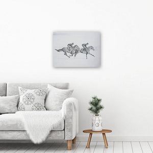 Black and white horse art picture on canvas, showing a pencil drawing of two horses galloping. It hangs unframed in an interior