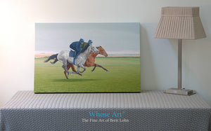 Canvas Horse art print showing a painting of a bay and grey racehorse exercising on the gallops. Rests in an interior setting