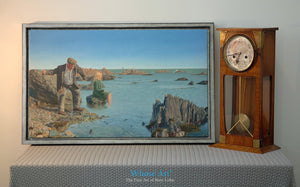 Canvas wall art print depicting a man skimming stones across a seascape. The canvas print is framed & rests on a table.