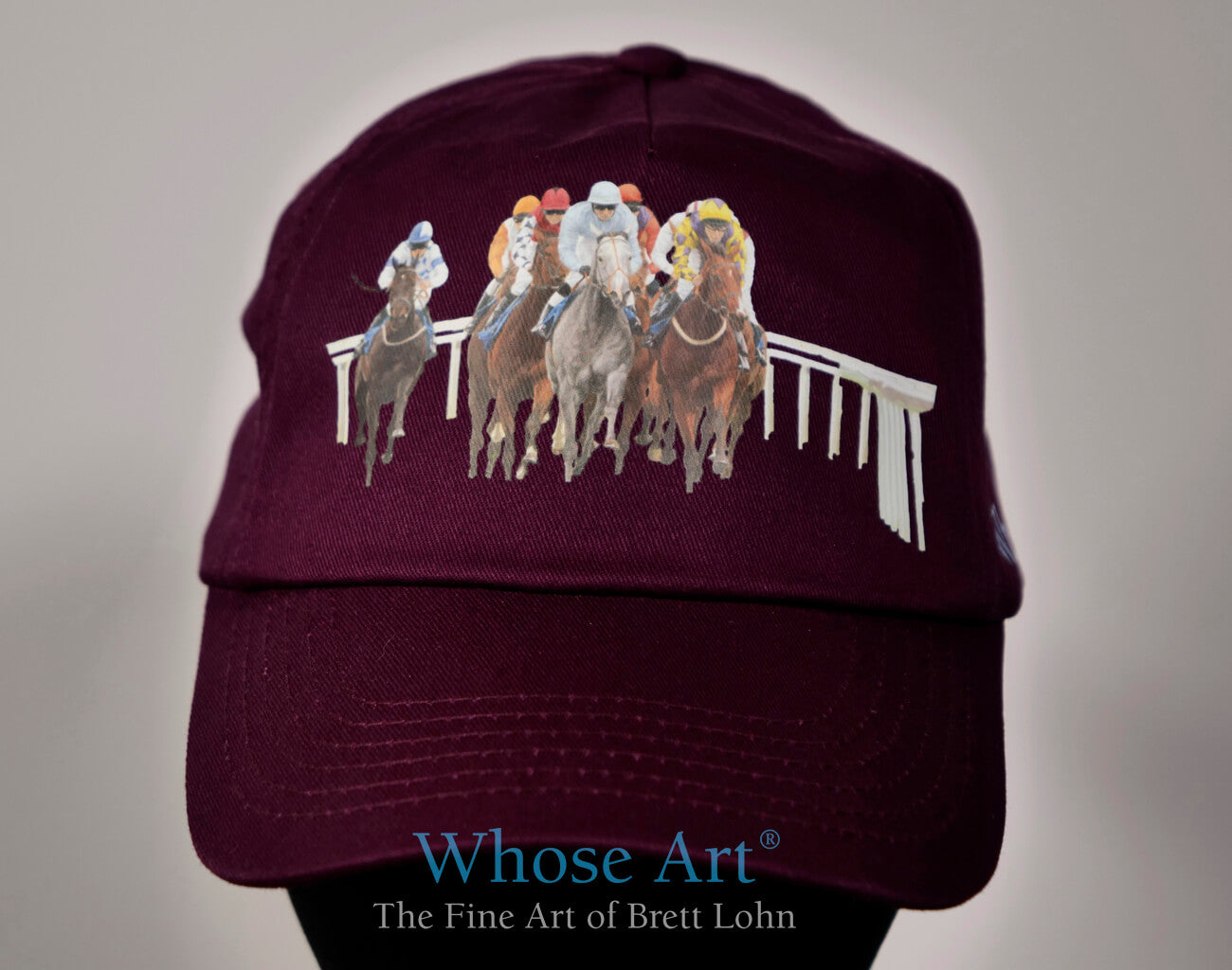 horse racing hat accessories.  burgundy hat with a picture of horse racing on the front