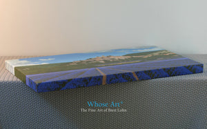 Gallery Canvas wrap of a painting of lavender fields. Fine art print laying on a table to display the wrap around edges.