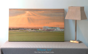 Horse racing Derby canvas art print displayed on a table leaning against a wall. The canvas print features racing at Epsom