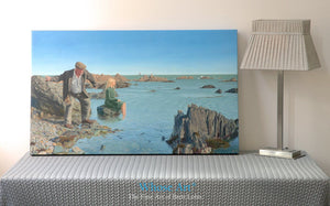 Narrative canvas wall art print from an oil painting telling a story of an old man by the sea. Canvas print rests on a table